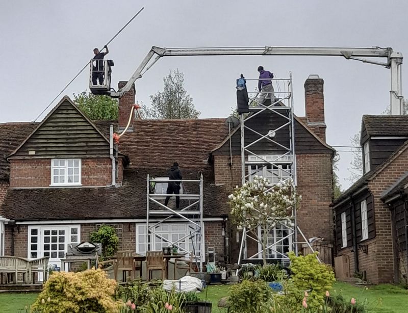 The Roof Moss Cleaners using cherry picker and scaffolding to clean roof safely and professionally in Whittlesey, Cambridgeshire